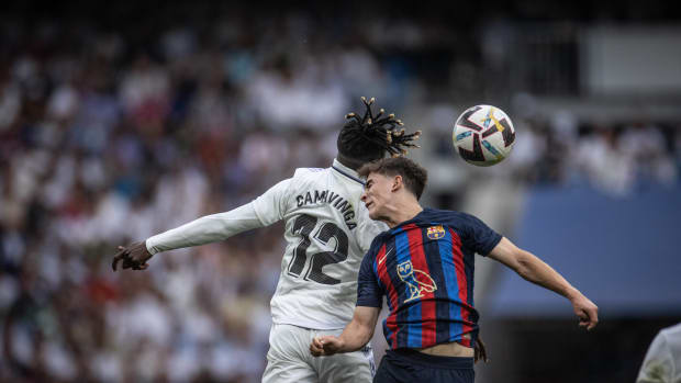 Barcelona midfielder Gavi pictured (right) jumping for a header against Real Madrid's Eduardo Camavinga in October 2022